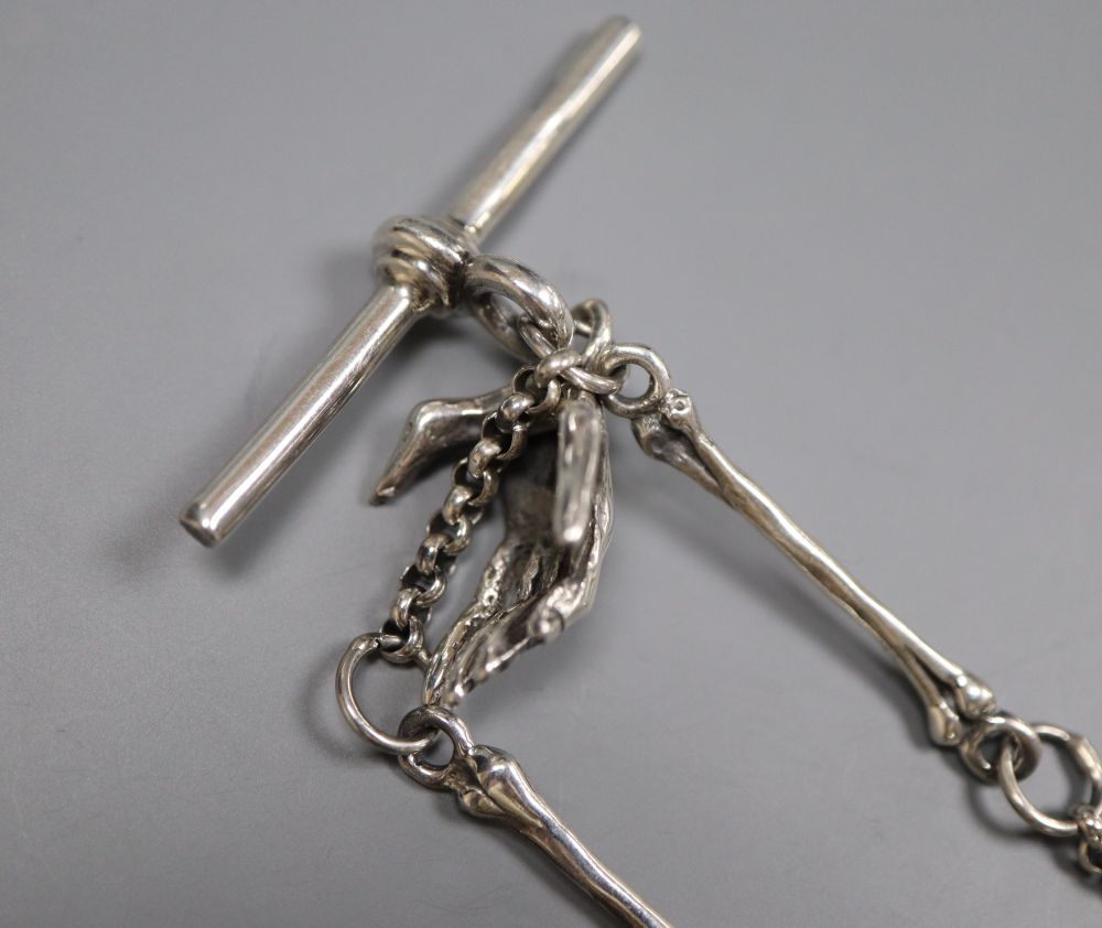 A sterling novelty skull locket?, on a skeletal albert chain, 32.5cm, gross 54 grams.